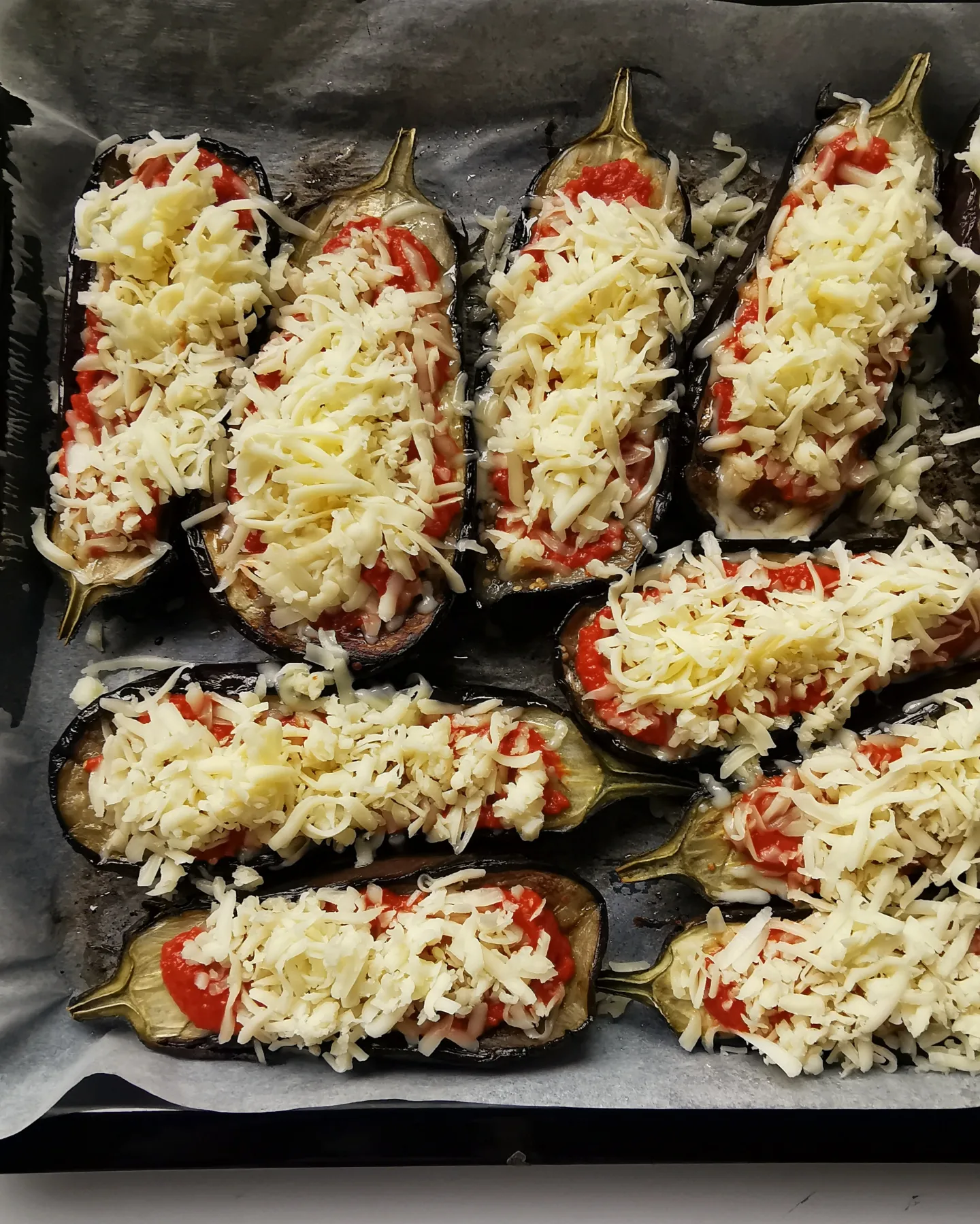 Roasted cheesy eggplants with red pepper sauce