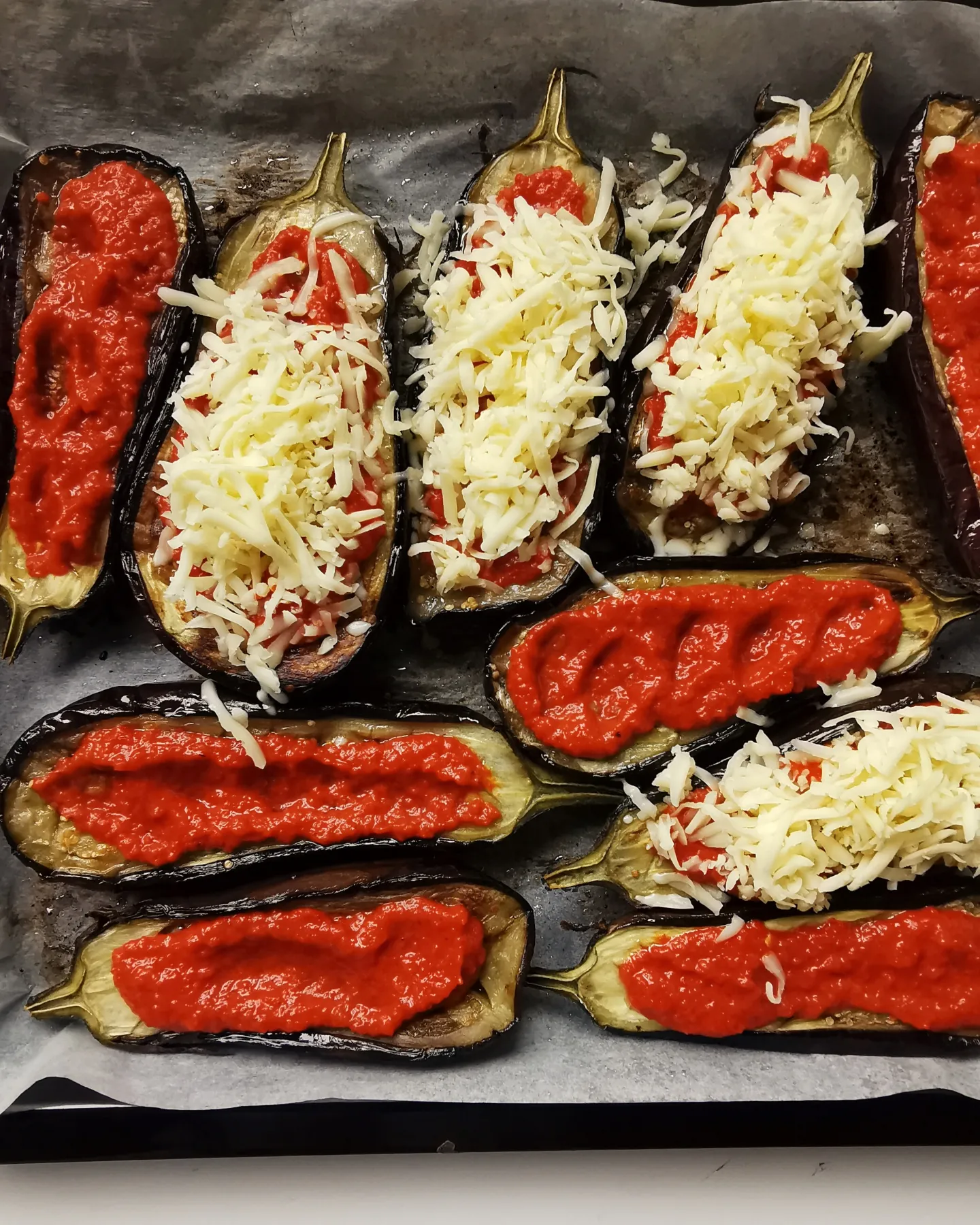 Roasted cheesy eggplants with red pepper sauce