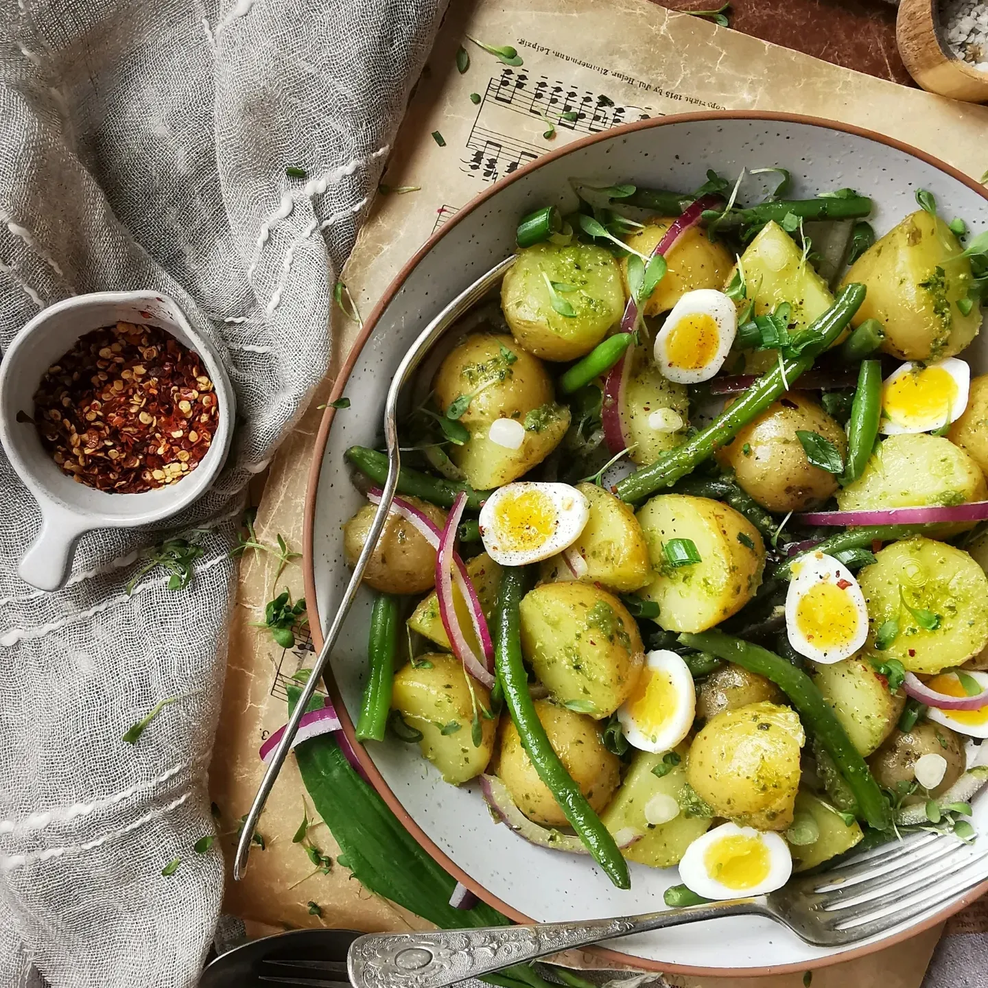 Warm potato salad with green beans, quail eggs and red onion